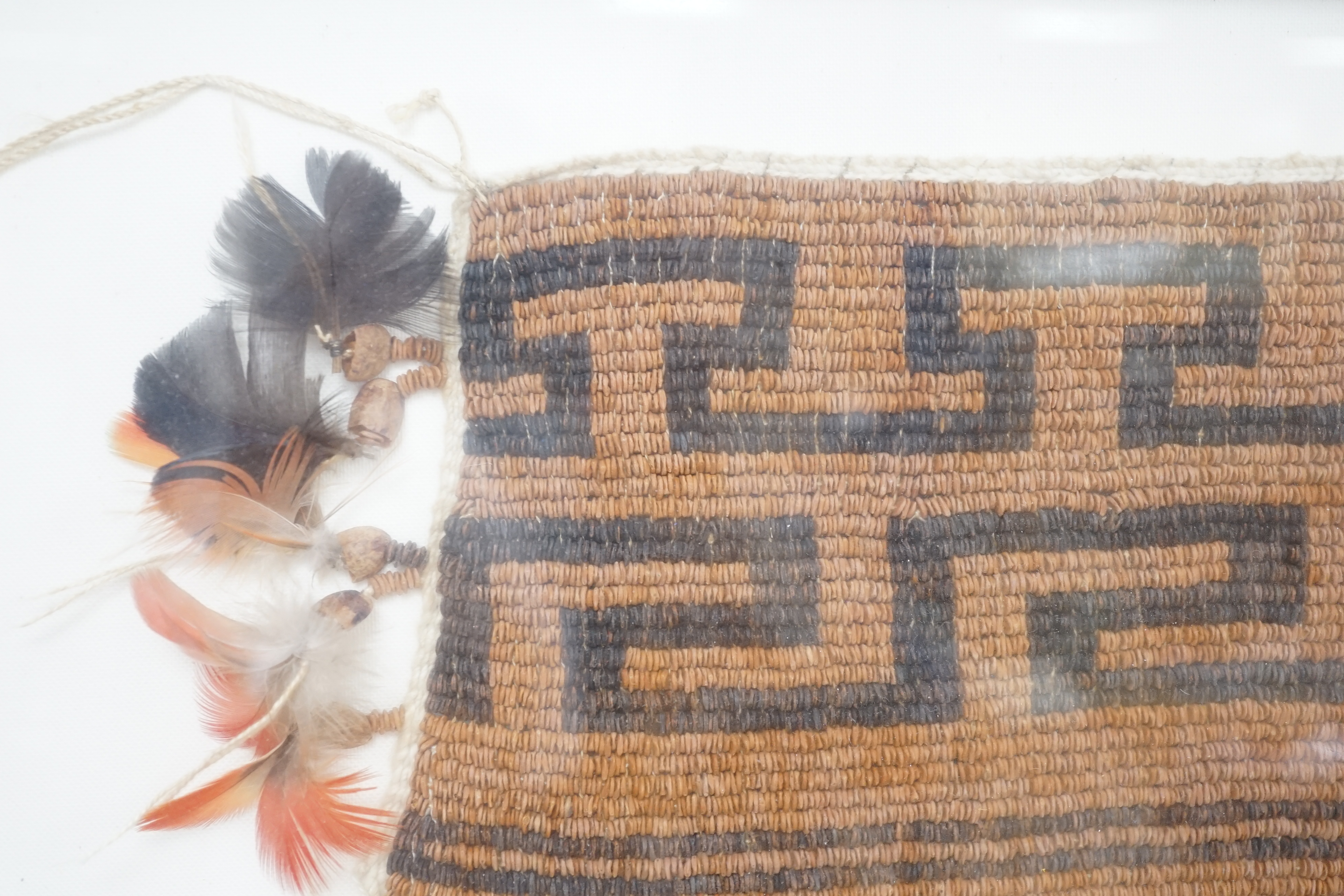 A framed textile possibly American Indian